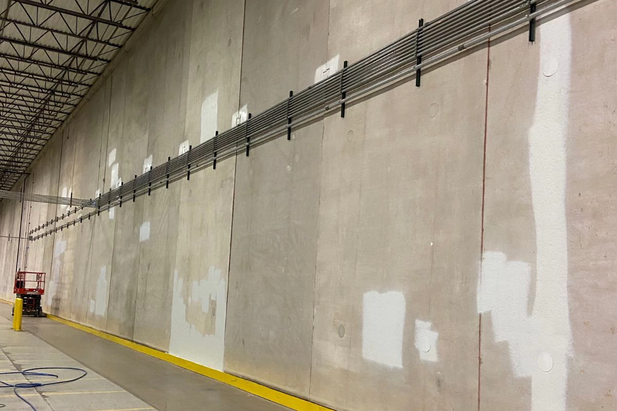 Warehouse interior wall with visible prep and patching areas before interior painting